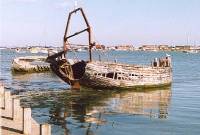 After a while, some of the old fishing boats mature from being an eyesore to almost an attraction. Since this picture was taken, the distant boat has all but disappeared.