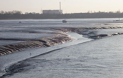 Shut Lake leading into Broom Channel in Langstone Harbour, from the Farlington Marshes sea-wall. New incinerator and Spinnaker tower in the background. A Little Egret is just visible in the channel.